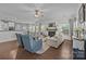 Cozy living room features a fireplace, ceiling fan, wood flooring, and large windows for natural light at 9871 Travertine Trl, Davidson, NC 28036