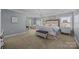 This main bedroom offers two bright windows, neutral paint, and a seating area for relaxation at 9871 Travertine Trl, Davidson, NC 28036