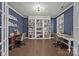 Stylish home office with built-in shelving, hardwood floors, and ample natural light at 9871 Travertine Trl, Davidson, NC 28036