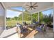 Inviting screened porch area with comfortable seating, outdoor ceiling fan, and green backyard views at 9871 Travertine Trl, Davidson, NC 28036