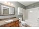 Standard bathroom with a granite countertop and tub shower with storage at 10421 Columbia Crest Ct, Charlotte, NC 28270