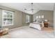 Spacious bedroom featuring carpeted floors, natural light, and modern ceiling fan at 10421 Columbia Crest Ct, Charlotte, NC 28270