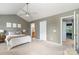 Comfortable bedroom with ceiling fan, gray walls, and doorway access to bathroom at 10421 Columbia Crest Ct, Charlotte, NC 28270