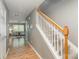 Entryway showing the staircase with natural wood handrail leading to the living area and front door at 10421 Columbia Crest Ct, Charlotte, NC 28270