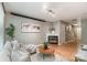 Comfortable living room features a fireplace, hardwood flooring, and stylish decor with lots of natural light at 10421 Columbia Crest Ct, Charlotte, NC 28270