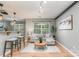 Bright living room featuring hardwood floors, a cozy sofa, and a view through the large window at 10421 Columbia Crest Ct, Charlotte, NC 28270
