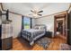 Comfortable bedroom featuring wood floors, a ceiling fan, and a cozy bed with decorative pillows at 105 Carrie Ln # 3, Cherryville, NC 28021