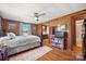 Cozy bedroom with wood paneled walls, hardwood floors, and natural light from the window at 105 Carrie Ln # 3, Cherryville, NC 28021
