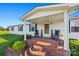 Inviting front porch with brick steps and rocking chairs, complemented by lush landscaping at 105 Carrie Ln # 3, Cherryville, NC 28021