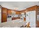 Well-lit kitchen with wood cabinets, white appliances, granite countertops, and a breakfast bar at 105 Carrie Ln # 3, Cherryville, NC 28021