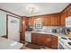 Functional kitchen with wood cabinets, white appliances, subway tile backsplash, and a double sink at 105 Carrie Ln # 3, Cherryville, NC 28021