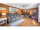 Cozy living room featuring wood paneling, a ceiling fan, hardwood floors, and comfortable seating at 105 Carrie Ln # 3, Cherryville, NC 28021
