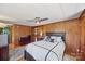 Comfortable main bedroom with wood paneling, a dark wood bed frame, and a neutral rug at 105 Carrie Ln # 3, Cherryville, NC 28021
