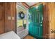 Functional mud room with a green exterior door leading to a bricked porch and grassy yard at 105 Carrie Ln # 3, Cherryville, NC 28021