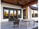 Covered patio features a ceiling fan, cedar ceiling, and a stone tile floor for outdoor relaxation and entertaining at 114 Wilharr Ct # 38, Mooresville, NC 28115