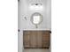 Bathroom features a modern vanity with a vessel sink, quartz countertop, and stylish round mirror at 114 Wilharr Ct # 38, Mooresville, NC 28115
