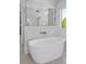 Bathroom showcases a modern freestanding tub with white subway tile and bronze fixtures at 114 Wilharr Ct # 38, Mooresville, NC 28115