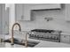 Close up of kitchen features a large island with a prep sink, gas range, and a pot filler faucet at 114 Wilharr Ct # 38, Mooresville, NC 28115