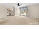 Open bedroom layout featuring carpet, a ceiling fan, and an en suite bathroom vanity at 12117 Idlewild Rd, Matthews, NC 28105
