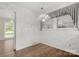 Cozy dining area featuring wood floors, white wainscoting, and a charming chandelier at 12117 Idlewild Rd, Matthews, NC 28105