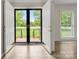 Inviting entryway with double doors, beautiful floors, and plenty of natural light at 12117 Idlewild Rd, Matthews, NC 28105