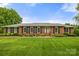 Charming brick home featuring manicured lawn and mature landscaping in a desirable neighborhood at 12117 Idlewild Rd, Matthews, NC 28105