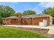 Exterior showcasing the brick home with a deck, patio, and attached garage, offering convenience at 12117 Idlewild Rd, Matthews, NC 28105
