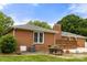 Brick home with a backyard, deck, and patio, perfect for outdoor living and entertaining at 12117 Idlewild Rd, Matthews, NC 28105