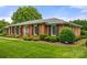 Charming brick home with lush landscaping and manicured lawn in a desirable neighborhood at 12117 Idlewild Rd, Matthews, NC 28105