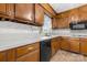 Functional kitchen with white countertops, wood cabinetry, and modern appliances at 12117 Idlewild Rd, Matthews, NC 28105