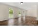 Spacious living room with hardwood floors and multiple windows providing ample natural light at 12117 Idlewild Rd, Matthews, NC 28105