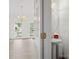 Powder room view with a pedestal sink and a view of an adjacent living space with chandelier at 12317 Panthersville Dr, Charlotte, NC 28269