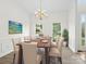Elegant dining room featuring a chandelier, table set for six, and natural light at 12317 Panthersville Dr, Charlotte, NC 28269