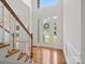 Inviting foyer with a glass-paneled front door, hardwood floors, and staircase at 12317 Panthersville Dr, Charlotte, NC 28269