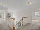 Upstairs hallway with carpet flooring and natural light from large window at 12317 Panthersville Dr, Charlotte, NC 28269