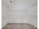 Walk-in closet features carpeted floor and multiple shelves for organizing clothes and accessories at 12317 Panthersville Dr, Charlotte, NC 28269