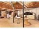 Partially finished basement with support beams and storage cabinets at 1407 Jodhpur Ct, Charlotte, NC 28212