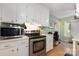 Well-lit kitchen featuring stainless steel appliances and white cabinetry at 1407 Jodhpur Ct, Charlotte, NC 28212