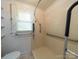 Bathroom featuring a walk-in shower with safety bars and a bright window at 1468 Hilltop St, Albemarle, NC 28001