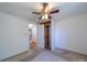 Bedroom with neutral carpet, ceiling fan, and closet space at 1468 Hilltop St, Albemarle, NC 28001