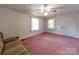 Bedroom with carpeted floors, two windows, and a ceiling fan at 1468 Hilltop St, Albemarle, NC 28001