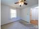 Cozy bedroom with neutral carpet, natural light, and ceiling fan at 1468 Hilltop St, Albemarle, NC 28001