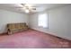 Bedroom with pink carpeting, a ceiling fan, and a window for natural light at 1468 Hilltop St, Albemarle, NC 28001