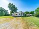 Charming single story home featuring a screened in porch, mature trees, and a large front yard at 1468 Hilltop St, Albemarle, NC 28001