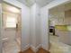 Hallway view with access to the bathroom and kitchen, showcasing the floor plan of the home at 1468 Hilltop St, Albemarle, NC 28001