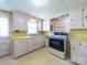 Traditional kitchen featuring laminate countertops, cabinetry, and modern oven range at 1468 Hilltop St, Albemarle, NC 28001