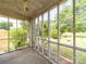 Inside view of the screened-in porch with views of the surrounding lush greenery and yard at 1468 Hilltop St, Albemarle, NC 28001