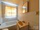 Small bathroom with yellow and white features at 1470 Hilltop St, Albemarle, NC 28001