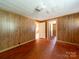 Bedroom featuring wood paneling and hardwood floors at 1470 Hilltop St, Albemarle, NC 28001