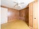 A bedroom with wood paneling, laminate flooring, and a ceiling fan at 1470 Hilltop St, Albemarle, NC 28001